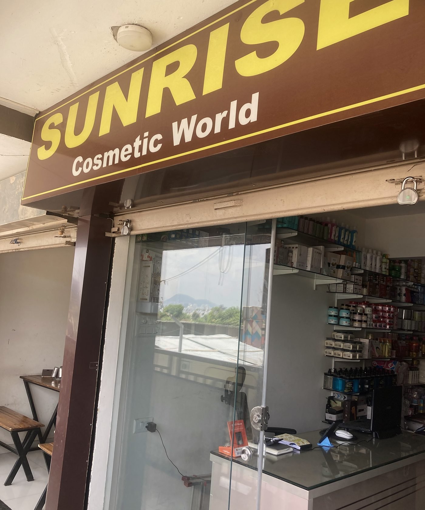 The Sunrise Cosmetic World storefront with its illuminated sign